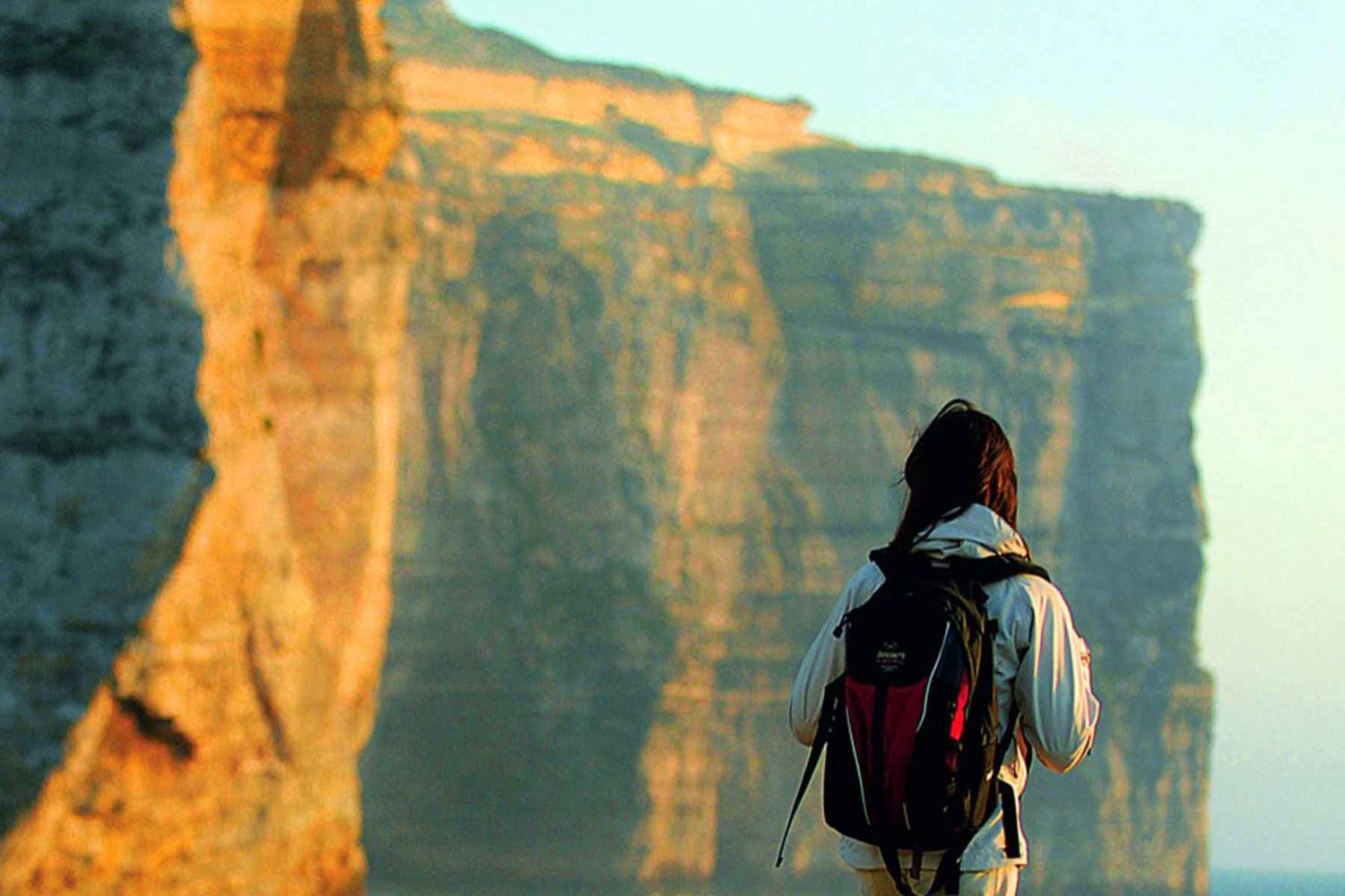 hiker walking on the cliff-